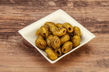 Green grilled olives in the bowl