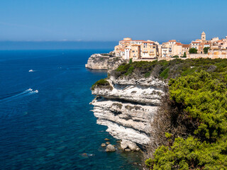 Fototapeta na wymiar Corsica Bonifacio white cliff with citadel old town facing the Mediterranean Sea during sunny day.