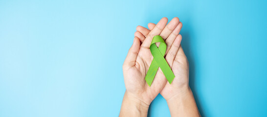 September World lymphoma and October Mental health day Awareness month, Woman holding lime green...