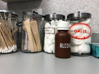 Cotton balls, tongue depressors and gauze sitting on a counter in a Doctor's office