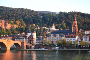 Obraz premium View of Heidelberg old town and Castle with Old Bridge over the river Neckar during sunset in autumn in Heidelberg, Germany