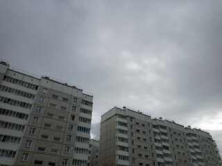 Fototapeta na wymiar Multi-storey monotonous houses against the sky, modern architecture