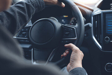 Man driving car and turning steering wheel