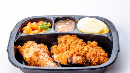 Frozen chicken dinner with ice crystals on it