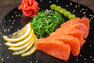Salmon sashimi on black dish