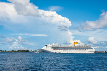 Fototapeta na wymiar A large white cruise ship near the city of Male in the Indian ocean