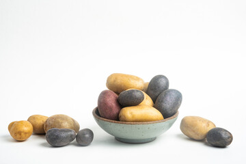 Assorted Color Potatoes On Bowl And Table