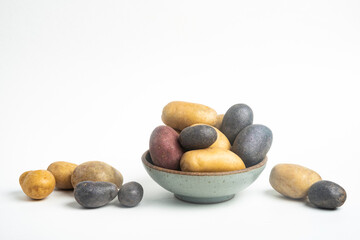 Fototapeta na wymiar Assorted Color Potatoes On Bowl And Table