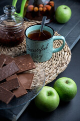 Tea set on a wooden table, on a dark background.