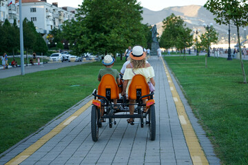 a family bike ride along the beautiful embankment of the resort town