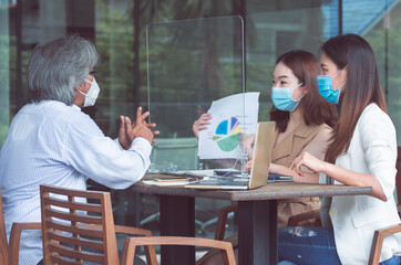 Obraz premium Group of people wearing masks and working together