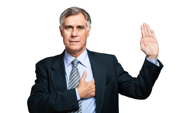 Senior businessman or politician making an oath sign with his hand