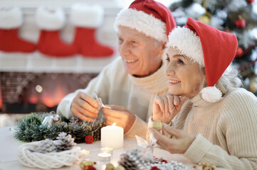 Happy senior couple preparing for Christmas at home