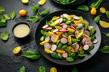 Cucamelon salad with radish, tomato, spinach and mustard dressing. Healthy food.