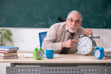 Old male teacher in the classroom