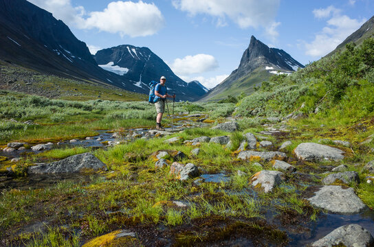 Hiking in Swedish Lapland. Man trekking alone in northern Sweden. View of Nallo mountain, Arctic nature of Scandinavia in summer day
