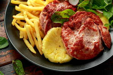 Fried Gammon steak with pineapple, french fries and vegetables