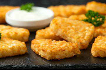 Hash brown potato patties on rustic stone board