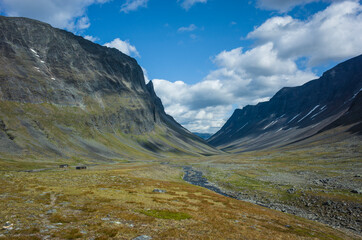 Picturesque Swedish Lapland landscape. Nallo mountain hut in northern Sweden. Arctic environment of Scandinavia in summer sunny day with fluffy clouds
