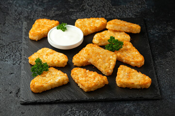Hash brown potato patties on rustic stone board