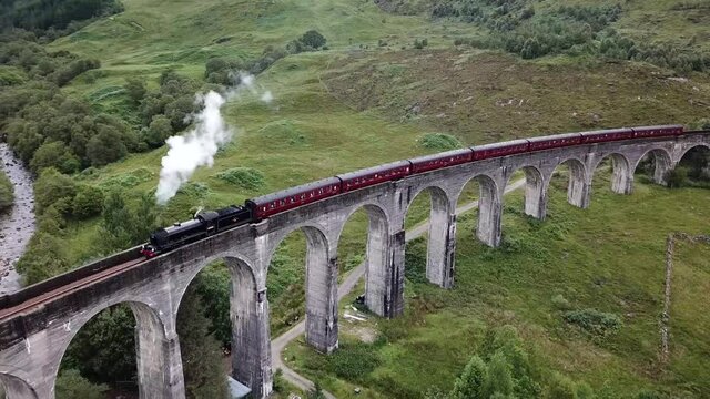 Aerial shot of the Jacobite steam train crossing the Glenfinnan Viaduct in Scotland (of Harry Potter fame)