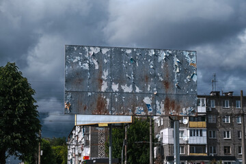 An empty, rusty billboard on a building background