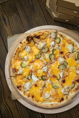 Pizza, in stock. on a brown wooden table.
