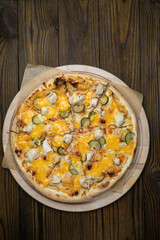 Pizza, in stock. on a brown wooden table.
