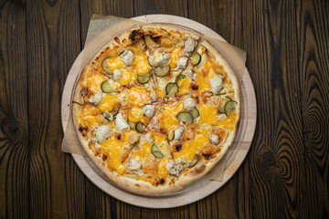 Pizza, in stock. on a brown wooden table.

