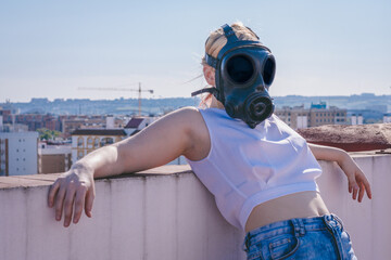 portrait of a woman posing and wearing a gas mask