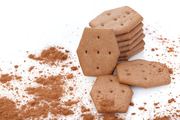 Sweet crackers with cocoa isolated on white background. Cracker sprinkled with cocoa. Close-up. There is free space for your text or sign.