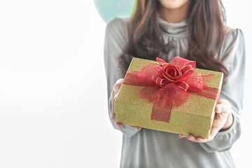 Happy New Year, Christmas and Holiday Seasonal Concept. Close up of beautiful gift box holding and present to camera by asian young woman with copy space for text
