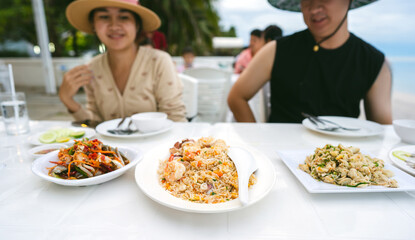Thai style egg fried rice with on table with people background
