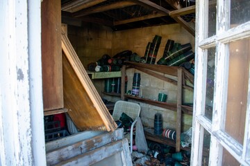 An Abandoned Store Room Next to a Greenhouse Full of Empty Pots and Garbage