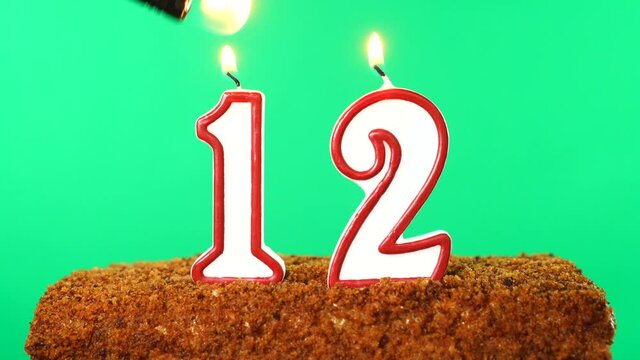 Cake with the number 12 lighted candle. Chroma key. Green Screen. Isolated