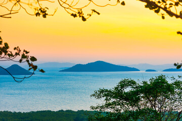 Mountain island landscape on sunset sea with colorful sunset sky