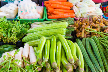 Food market with stall full of asian fruits and vegetables. Thailand fresh groceries