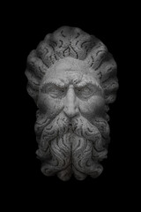 Obraz premium Portrait of ancient aged sculpture of an old Venetian bearded man in Venice at black background, Italy