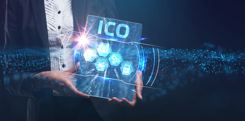 Business, Technology, Internet and network concept. Young businessman working on a virtual screen of the future and sees the inscription: ICO