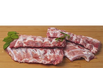 Fototapeta premium Close up view of raw pork ribs on wooden cutting broad. Cooking and food concept.