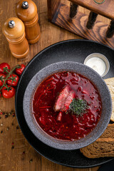 Borsch from the menu of a Ukrainian restaurant. On a wooden table
