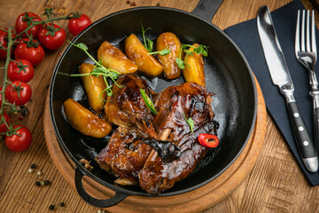 Grilled meat from the menu of an Italian restaurant. On a wooden table
