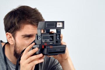 Fototapeta premium male photographer holding camera professional lens creative studio work light background