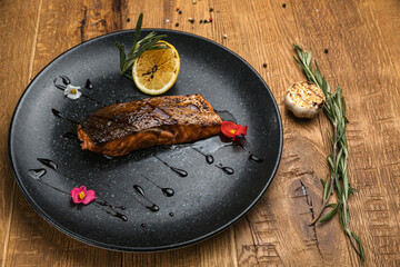 Grilled fish from the menu of an Italian restaurant. On a wooden table
