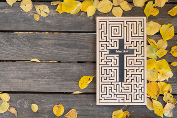 Autumn background. Wood carved word from John 14: 6 on a shabby wood plank with yellow leaves