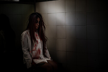 Portrait of asian woman make up ghost face with blood,Horror scene for background,Halloween...