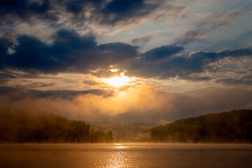 Fototapeta na wymiar Sunrise on a misty lake Vlasina in the south of Serbia