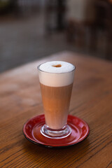 Iced latte coffee glass on wooden table in restaurant and cafe