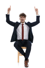 handsome businessman pointing up with both hands