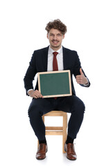 happy businessman holding a board and giving a ok sign